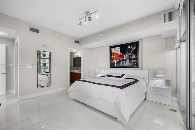 bedroom featuring ensuite bathroom and sink