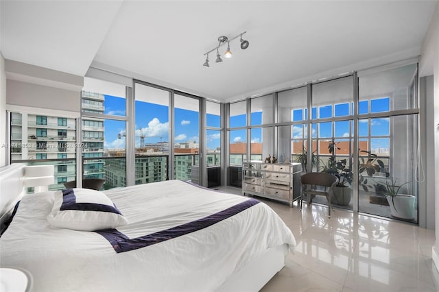 bedroom featuring floor to ceiling windows and light tile patterned flooring