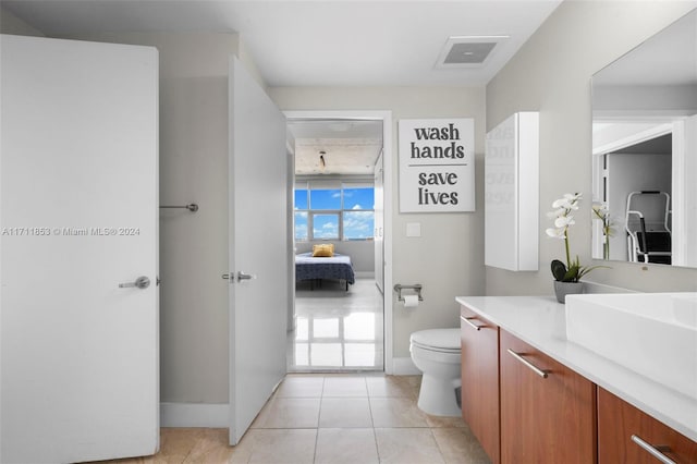 bathroom featuring toilet, vanity, and tile patterned floors