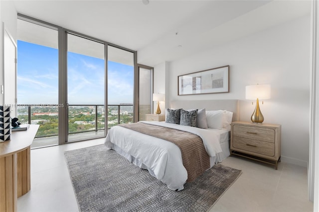 bedroom with access to exterior, floor to ceiling windows, and multiple windows