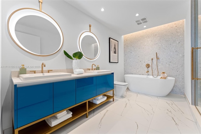 bathroom with a sink, visible vents, double vanity, and a soaking tub