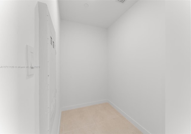 walk in closet with light tile patterned floors