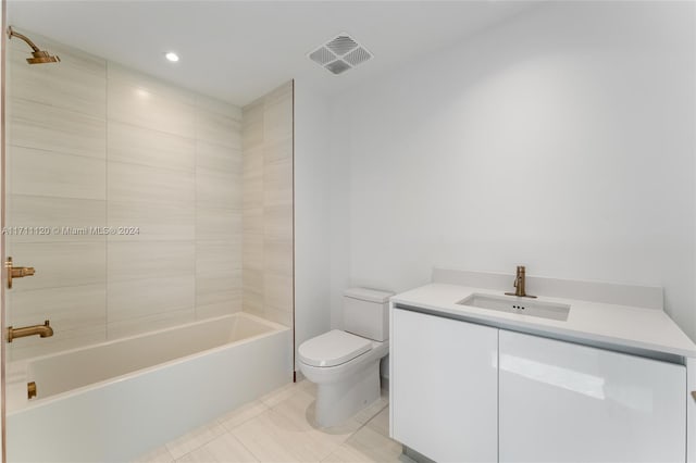 full bathroom featuring tile patterned floors, vanity, toilet, and tiled shower / bath