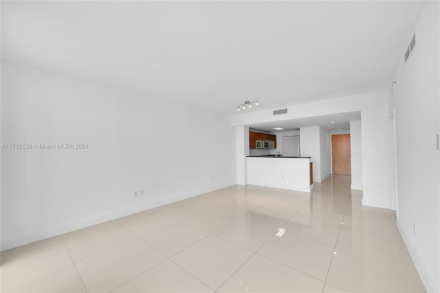 unfurnished living room with light tile patterned floors