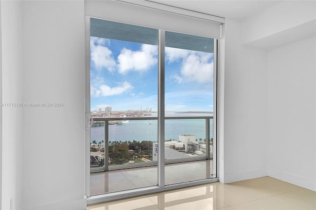 tiled spare room with a water view