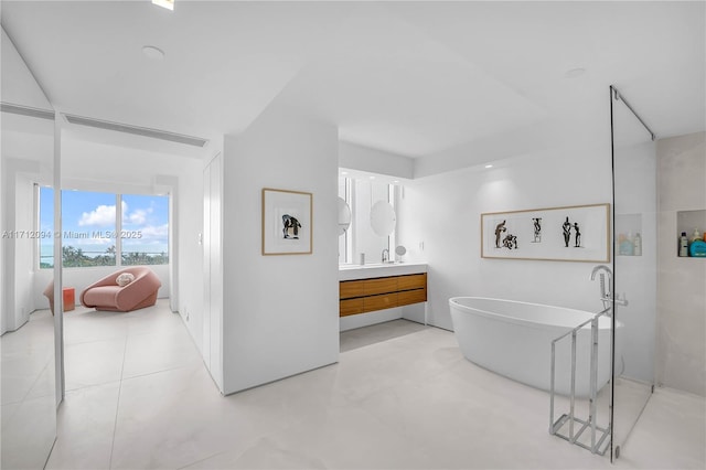 bathroom with vanity and a tub