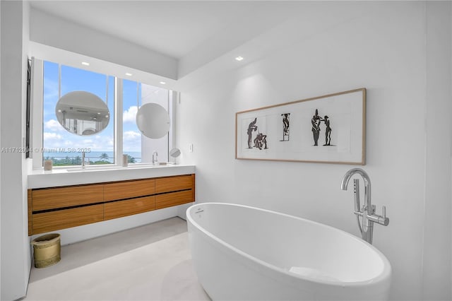 bathroom with vanity and a tub to relax in