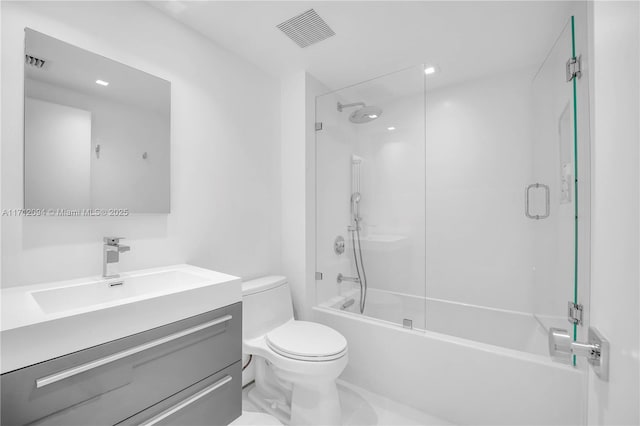 full bathroom featuring vanity, shower / bath combination with glass door, and toilet