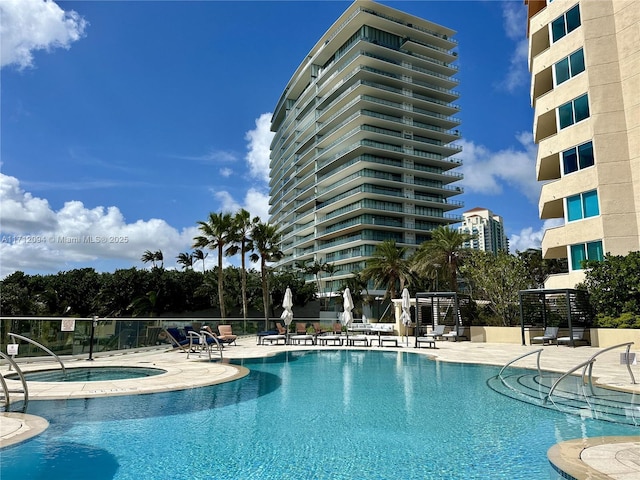 view of swimming pool featuring a patio area and a community hot tub