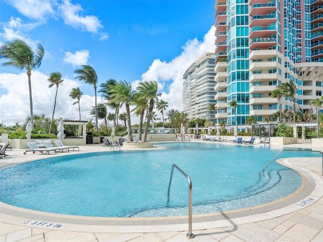 view of swimming pool featuring a pergola and a patio area