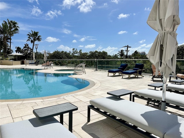 view of pool featuring an in ground hot tub and a patio area