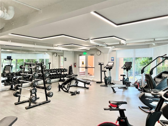 exercise room with hardwood / wood-style floors