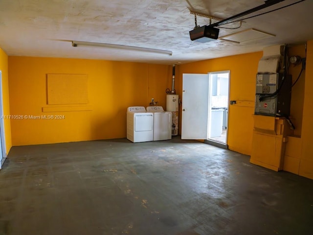 garage featuring heating unit, a garage door opener, and washer and clothes dryer