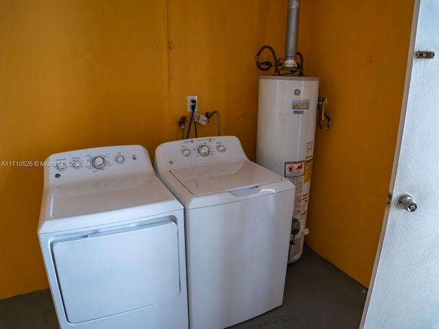 clothes washing area featuring water heater and washer and clothes dryer