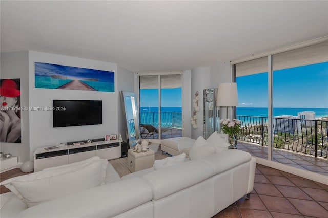 tiled living room featuring floor to ceiling windows