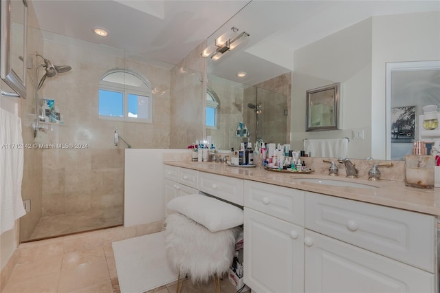 bathroom with tile patterned floors, vanity, and a shower with door