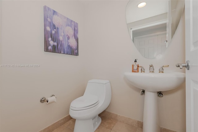 bathroom featuring tile patterned flooring and toilet