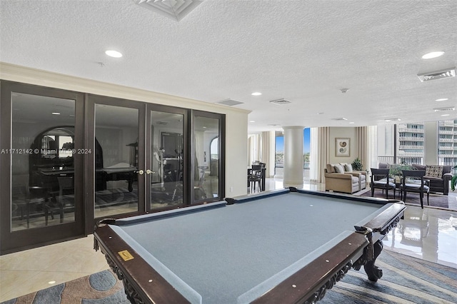 recreation room featuring decorative columns, light tile patterned floors, a textured ceiling, and billiards