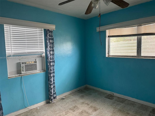 carpeted spare room with ceiling fan and cooling unit