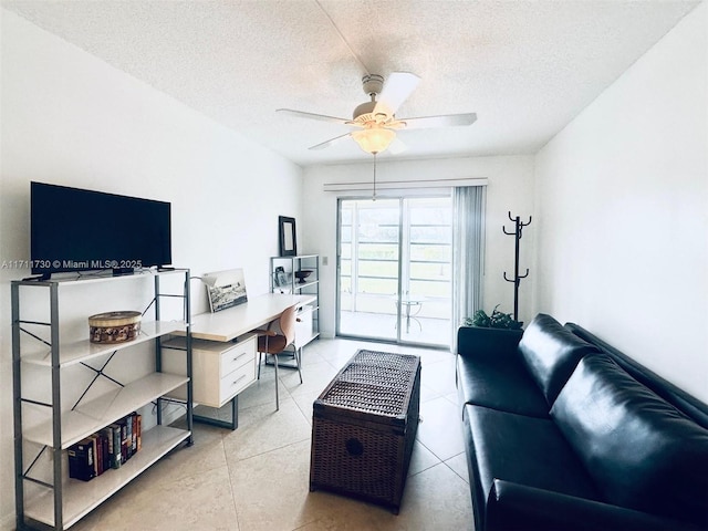 interior space with light tile patterned floors, a textured ceiling, and a ceiling fan