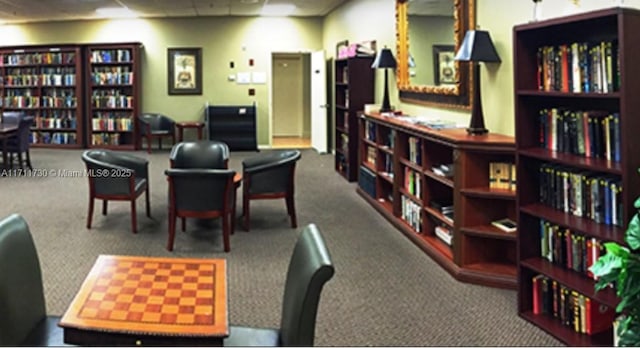 interior space with carpet flooring and a drop ceiling