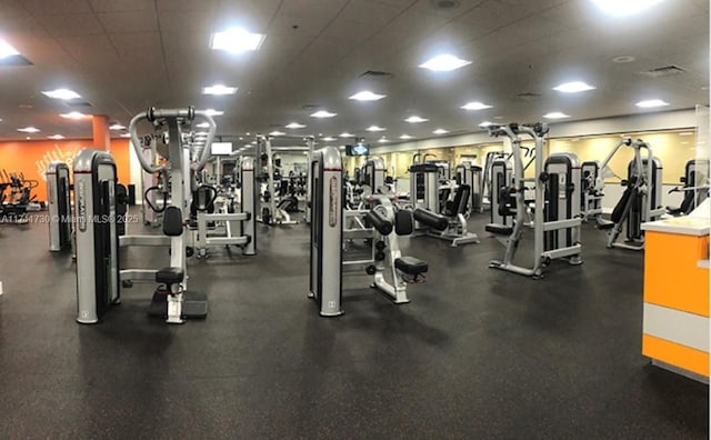 exercise room featuring a drop ceiling and visible vents