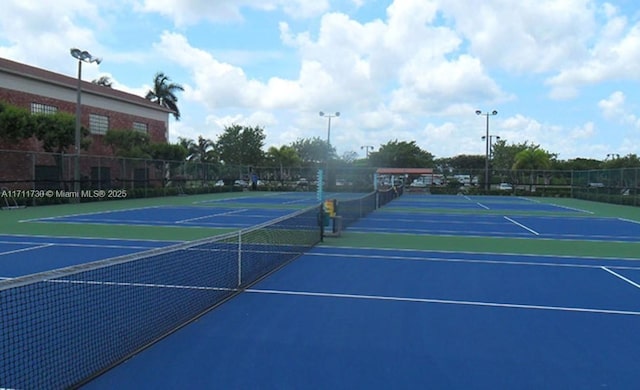 view of tennis court featuring fence