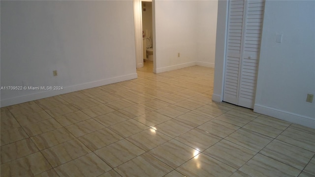 empty room with light tile patterned floors