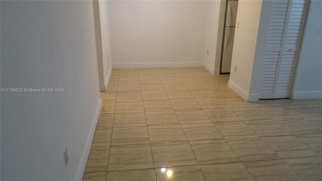 hall featuring light tile patterned floors