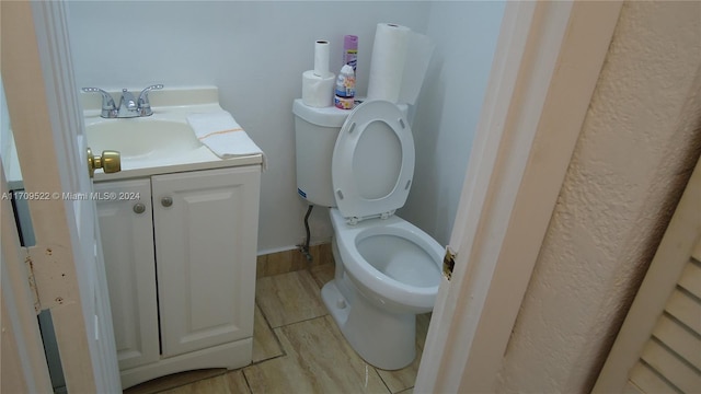 bathroom featuring hardwood / wood-style flooring, vanity, and toilet