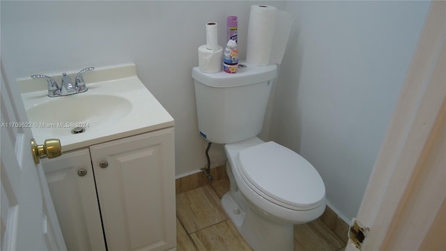 bathroom featuring vanity, toilet, and wood-type flooring