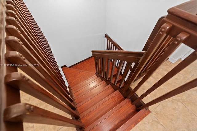 stairway featuring tile patterned flooring