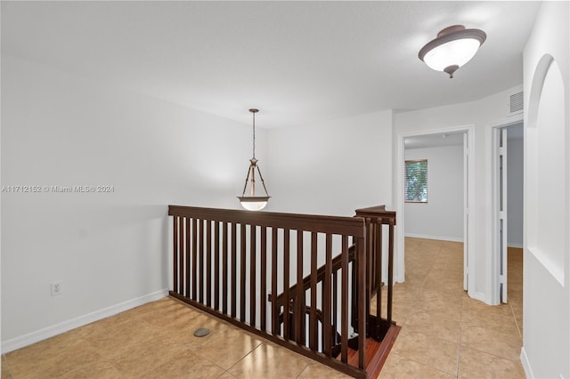 hall with light tile patterned flooring