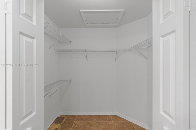 spacious closet with tile patterned floors