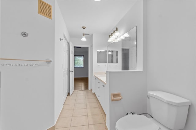 bathroom featuring tile patterned flooring, vanity, and toilet