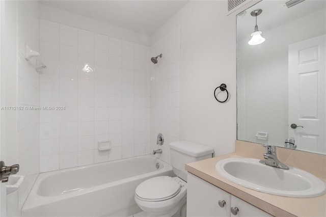 full bathroom featuring vanity, toilet, and tiled shower / bath