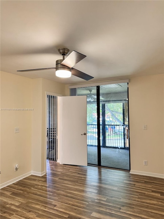 empty room with ceiling fan and dark wood-type flooring