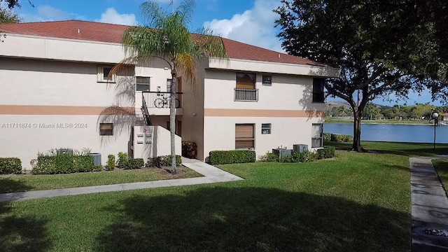 view of property featuring a water view and central air condition unit