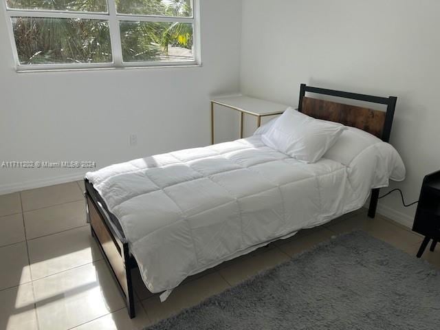 bedroom featuring light tile patterned flooring