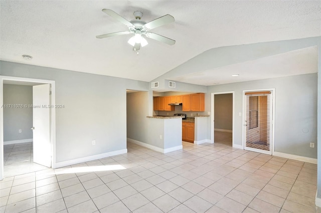 unfurnished living room featuring a textured ceiling, ceiling fan, light tile patterned flooring, and vaulted ceiling