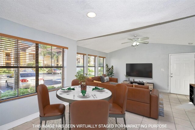 kitchen with light stone counters, light brown cabinetry, light tile patterned floors, and vaulted ceiling