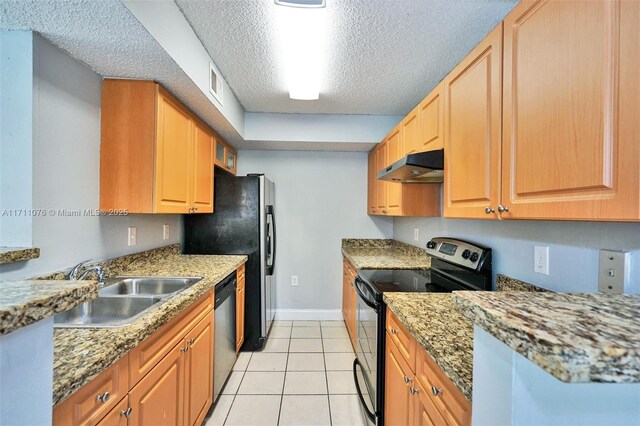 kitchen with a textured ceiling, light stone counters, stainless steel electric stove, and sink