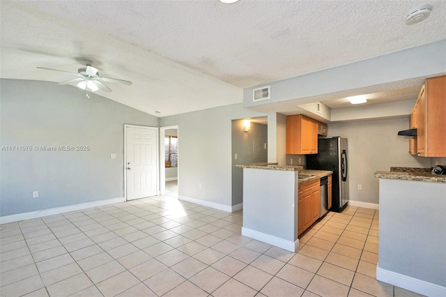 kitchen featuring lofted ceiling, light tile patterned floors, ceiling fan, stainless steel dishwasher, and exhaust hood