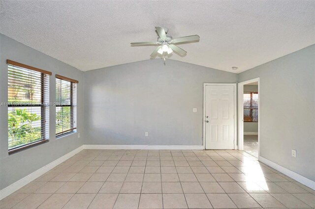 unfurnished bedroom with a spacious closet, a closet, ensuite bathroom, and a textured ceiling