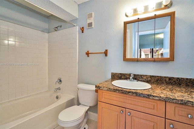 full bathroom featuring toilet, vanity, and tiled shower / bath