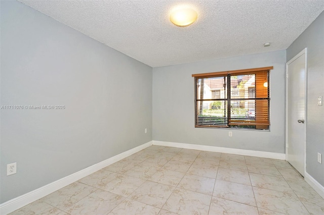 empty room with a textured ceiling