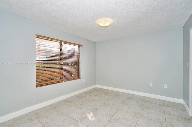 empty room with a textured ceiling