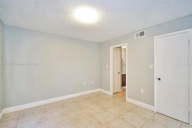 spare room featuring a textured ceiling