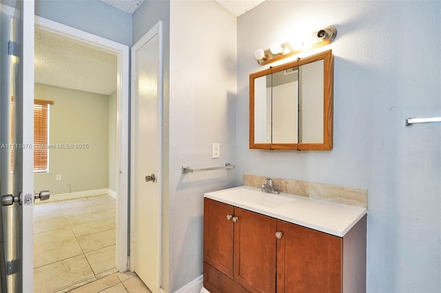 bathroom with vanity, tile patterned flooring, and a textured ceiling