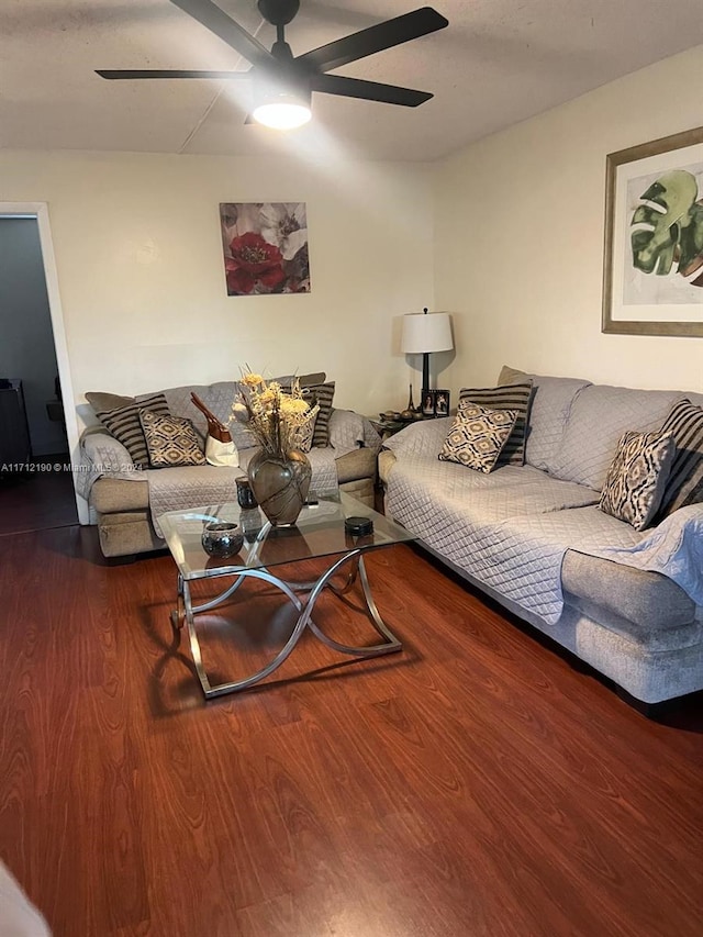 living room featuring hardwood / wood-style floors and ceiling fan